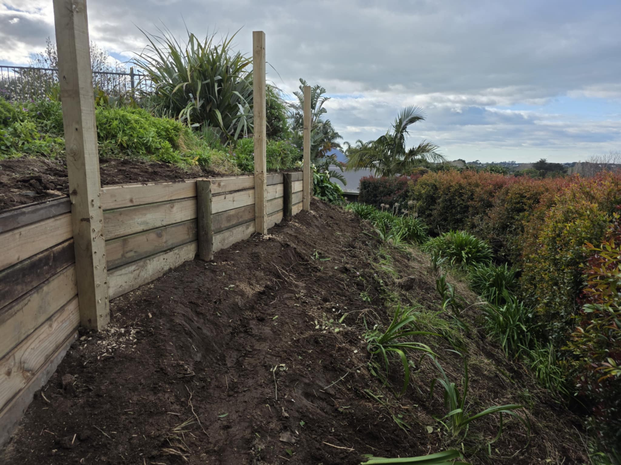 Finished retaining wall and planted slope