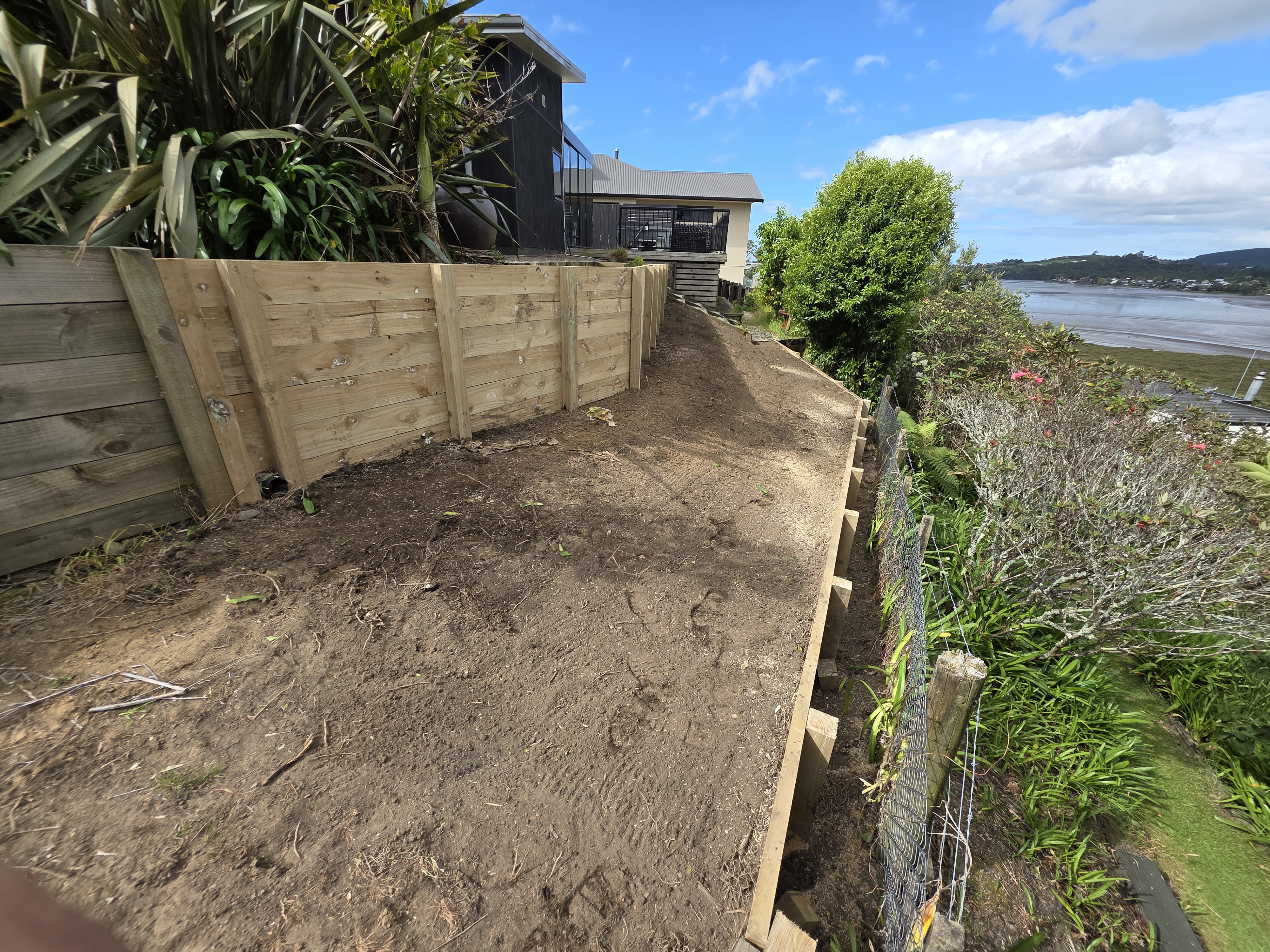 Retaining wall project with completed timber retaining wall